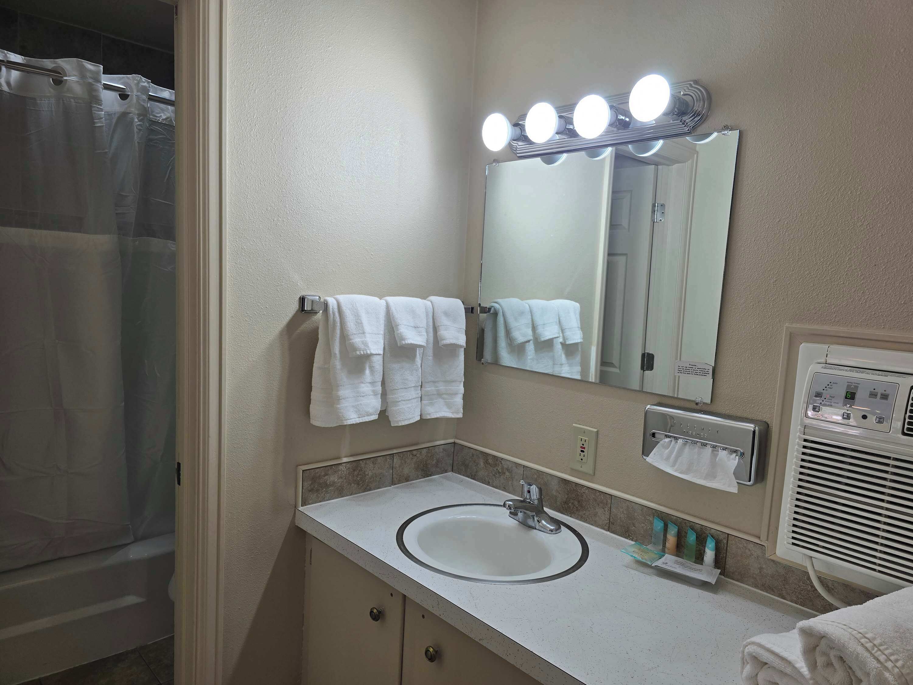 Shower, hair dryer, towels, shampoo
