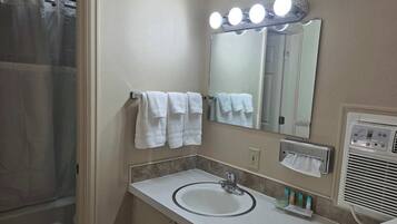 Shower, hair dryer, towels, shampoo
