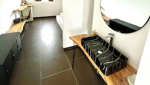 A modern, well-lit room with a wooden desk, a round mirror, and a black tray on a wooden table. - Oasis of peace and serenity, nestled in the countryside. (Mesagne)