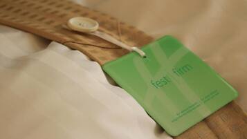 A tag with the text 'fest firm' on a fabric surface.