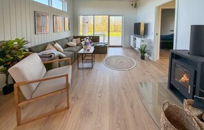 A modern living room with a sofa, armchair, TV, fireplace, and large windows. - Awesome home in Sydals with WiFi (Sydals)