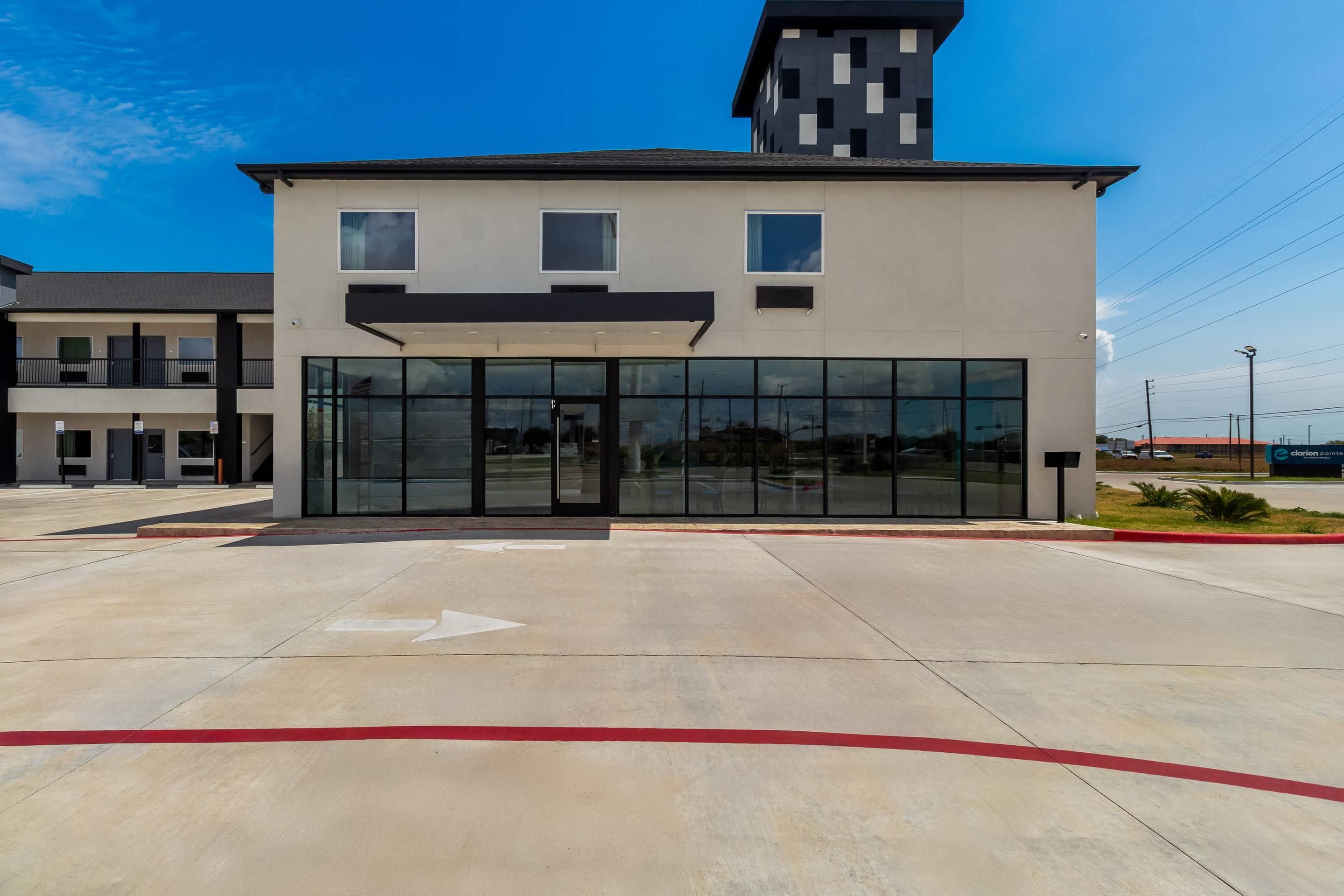A modern building with a flat roof, large glass windows, and a red curb.