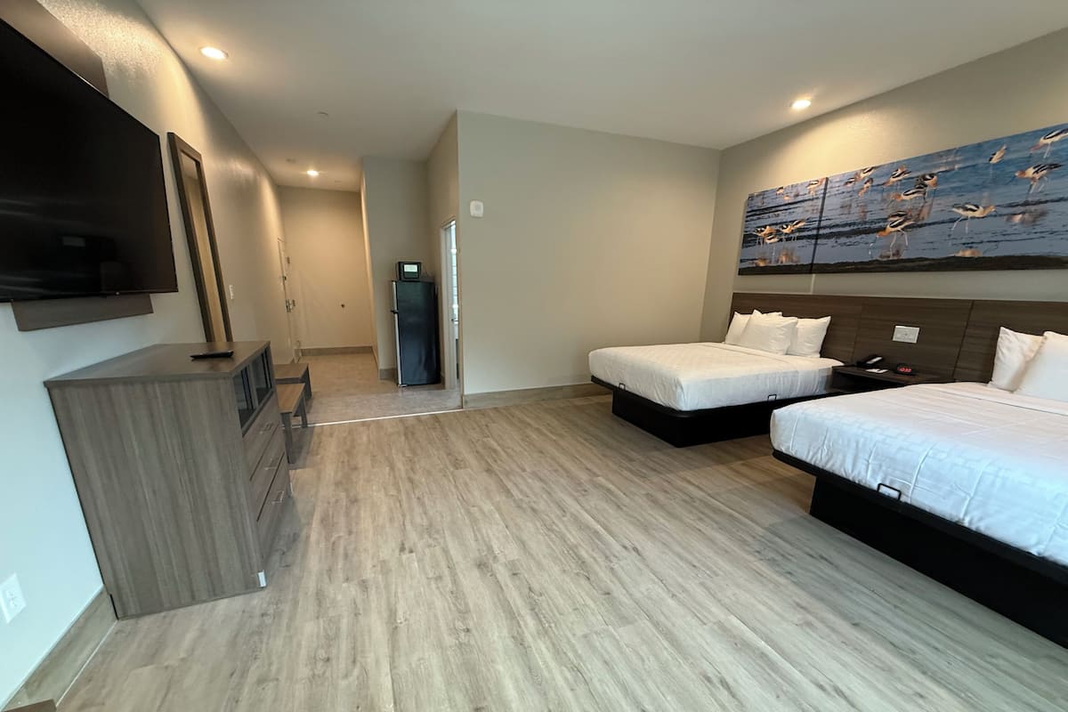 Premium bedding, laptop workspace, blackout drapes, soundproofing