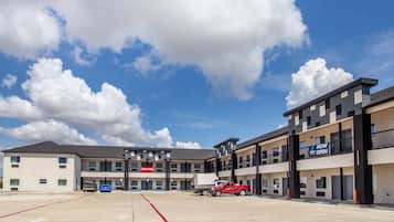 A multi-story parking structure with a clear sky and clouds.