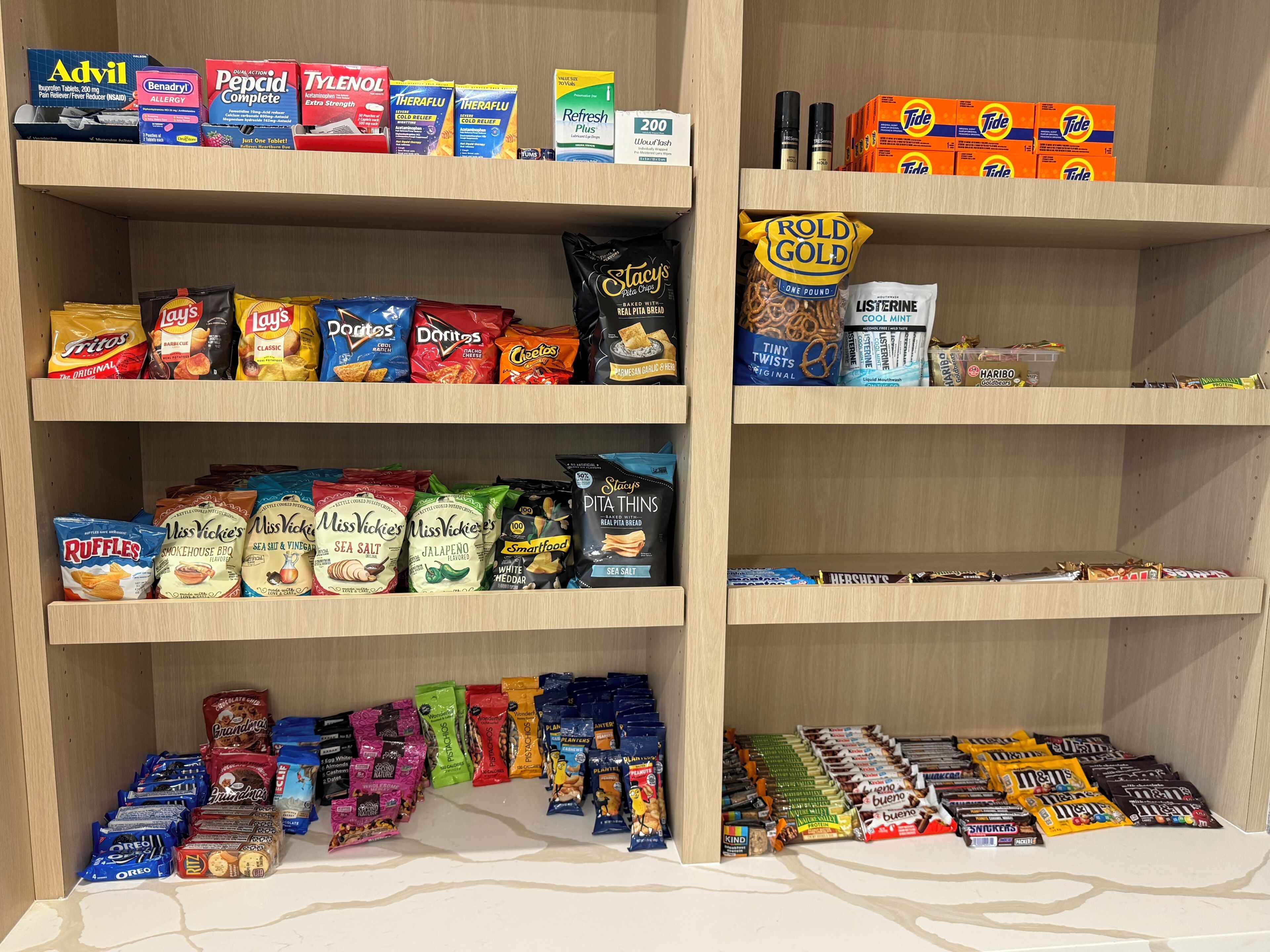 A shelf stocked with various snacks and personal care items.