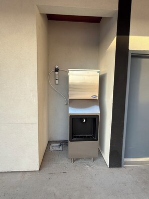 A compact kitchenette with a built-in oven, a small sink, and a water dispenser. - Clarion Pointe Port Lavaca (Port Lavaca)
