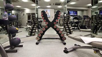 A gym with weightlifting equipment, treadmills, and exercise machines.