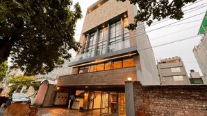 Un edificio moderno con estructura de dos pisos, ventanas amplias y una entrada visible.