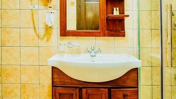 Shower, hair dryer, towels, shampoo