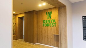 A hallway with wooden paneling and a sign that reads 'DENYA FOREST.'