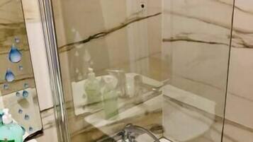 Shower, hair dryer, towels, shampoo