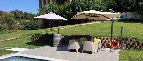 Seasonal outdoor pool, open 9:30 AM to 7:00 PM, pool umbrellas