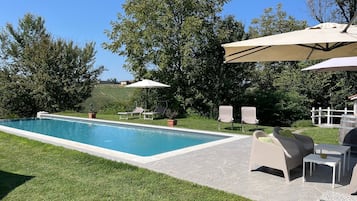 Seasonal outdoor pool, open 9:30 AM to 7:00 PM, pool umbrellas