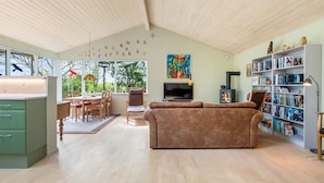 A spacious living area with a sofa, dining table, and bookshelf. - "Amina" - 500m from the sea by Interhome (Egå)