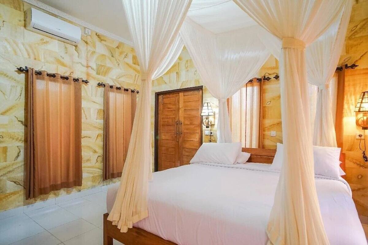 A bedroom with a four-poster bed, wooden doors, and a stone-patterned wall.