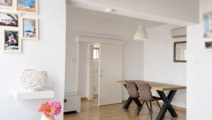 Ein modernes Interieur mit Essbereich, weißen Wänden und Holzboden.