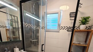 A modern bathroom with a glass-enclosed shower, a wooden vanity with a sink, and a towel rack. - Spacious T4 with views of the Alps (Seyssinet-Pariset)