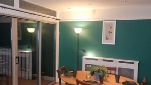 A dining area with a table, chairs, and a lamp. - Designer 5-Bedroom Home by Elizabeth Line (Greater London)