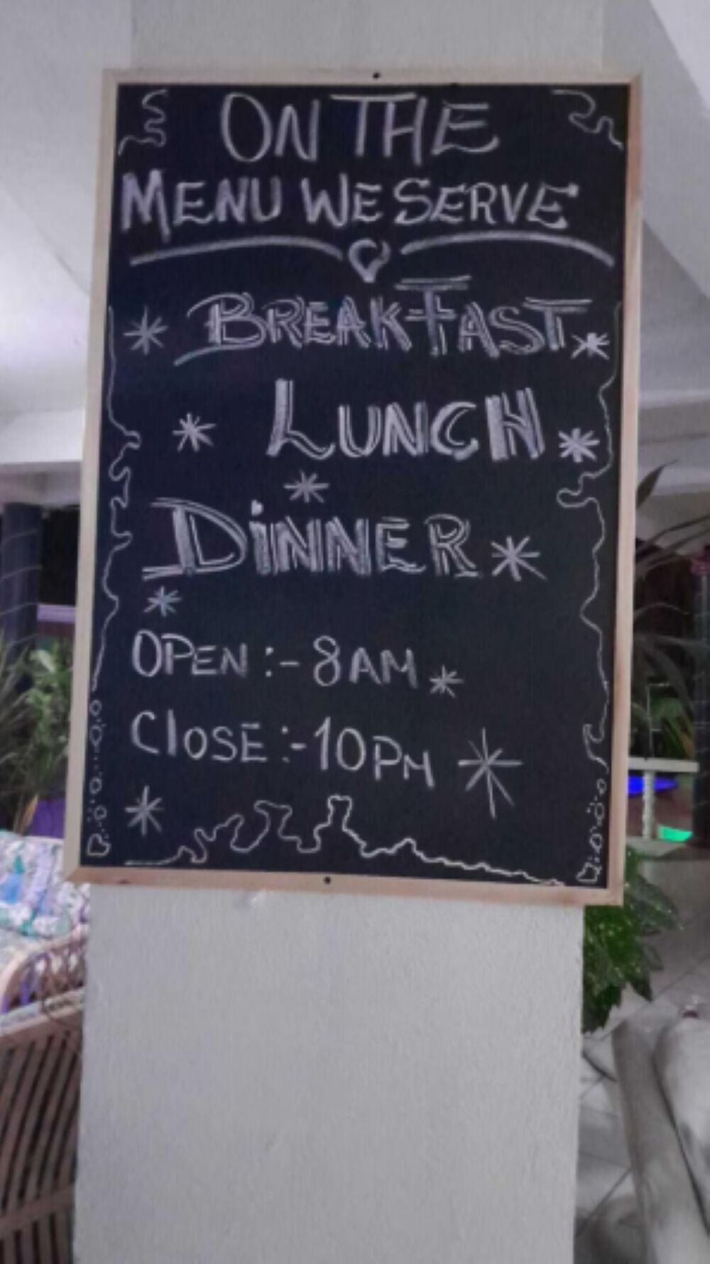 Pizarra con el horario de servicio de desayuno, almuerzo y cena, abierto desde las 8 de la mañana hasta las 10 de la noche.