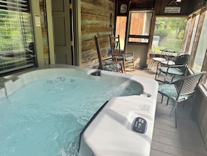 A hot tub with a control panel, wooden walls, and outdoor seating. - Historic Two-story Riverside Cabin w/Hot Tub in Gatinburg (Gatlinburg)