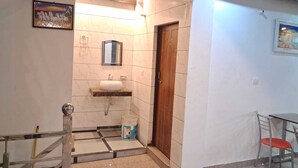 A bathroom with a sink, mirror, and tiled walls.