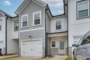 A two-story residential building with a garage, a front door, and a small porch area. - Easy Access to Golf Club & Dtwn: Augusta Basecamp (Evans)