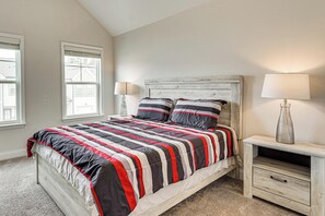 A bedroom with a bed, two bedside tables, and a window. - Easy Access to Golf Club & Dtwn: Augusta Basecamp (Evans)