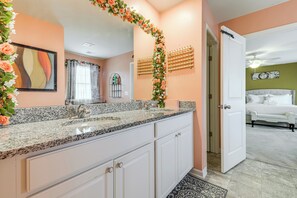 A bathroom with a double sink, a mirror, and a shower area. - Lakes, Gardens & More! Getaway in Moncks Corner (Moncks Corner)