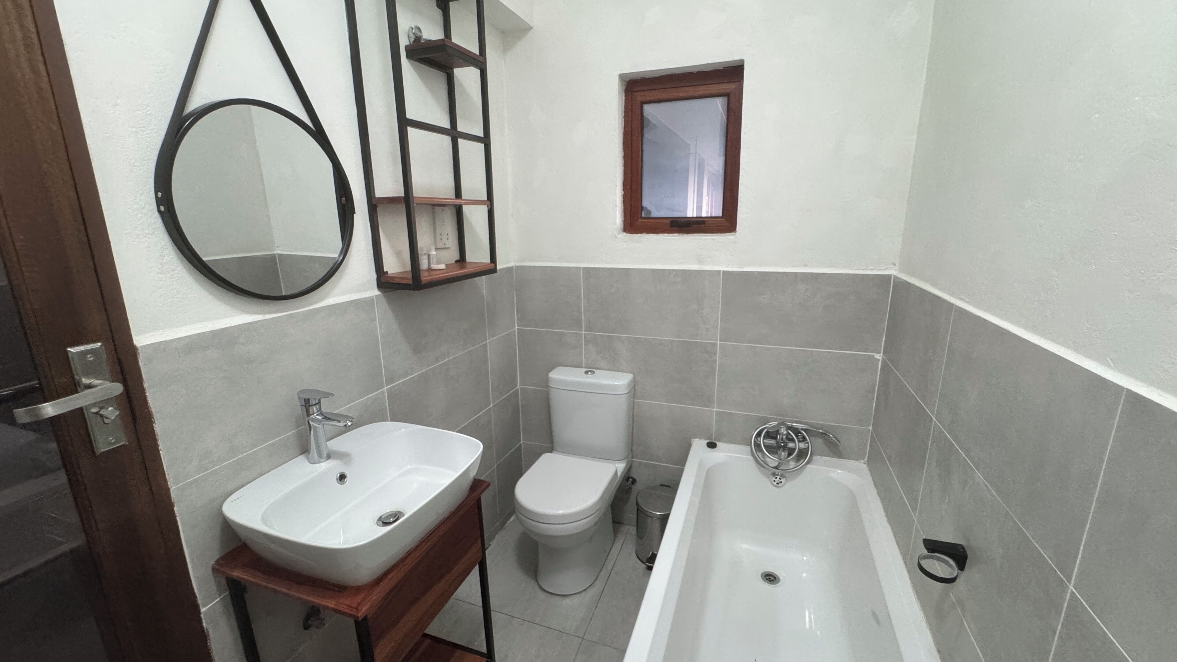 A bathroom with a sink, toilet, and bathtub.