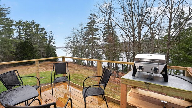 A deck with outdoor seating and a grill. - Forest Backdrop Midcoast Maine Quiet Escape 3 Bedroom Home (Dresden)