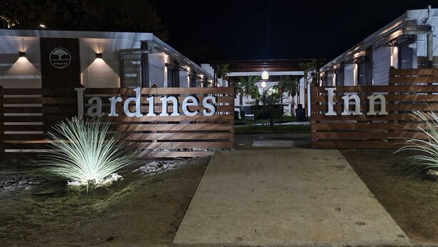 A gated entrance to a property with the name 'ardines inn' displayed prominently. - Jardines Inn (Trinidad)