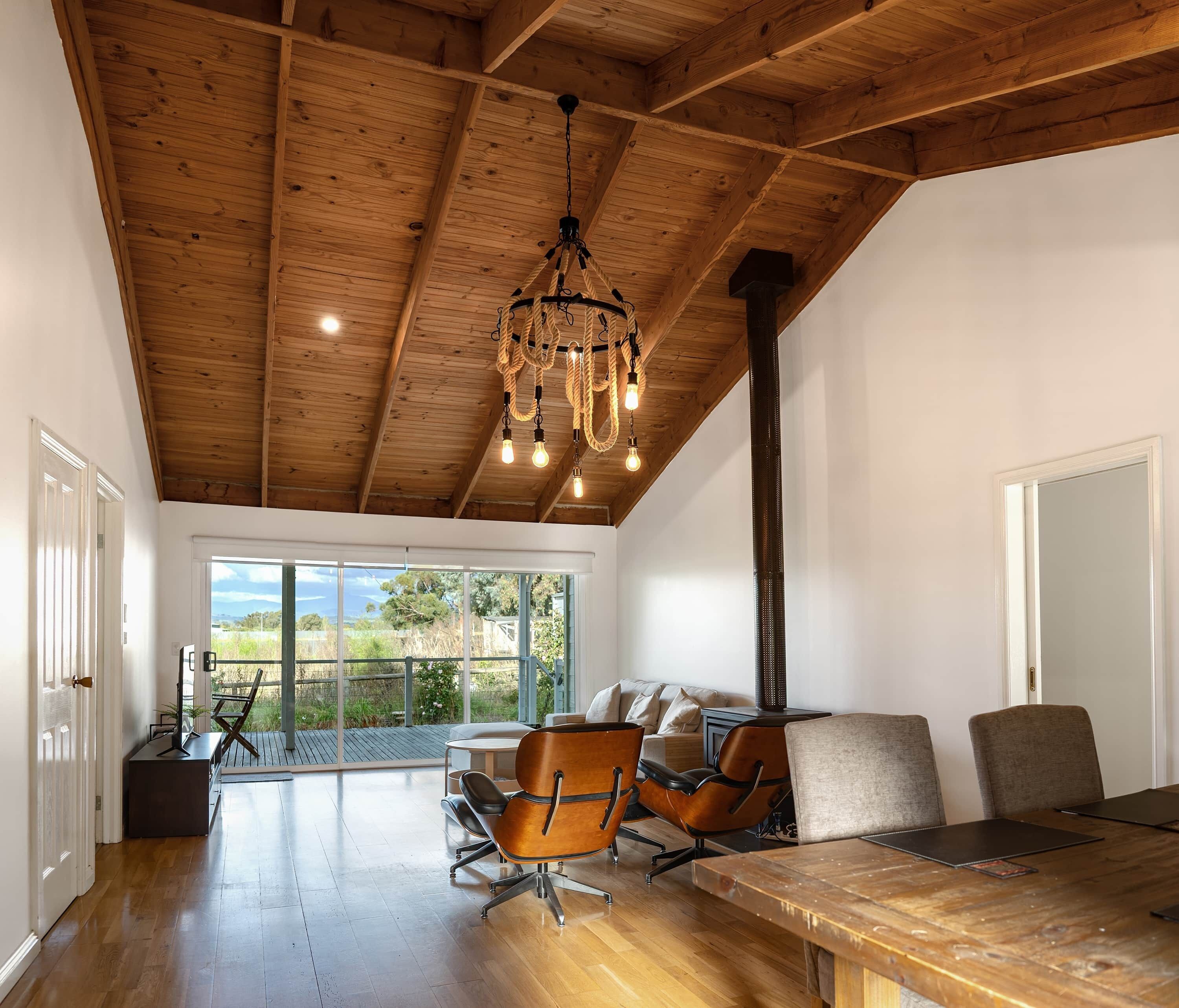 Living room & dining table with Mt Buller views. Split system in each and every living and bedroom.