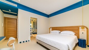 Een slaapkamer met een bed, een bureau en een stoel.