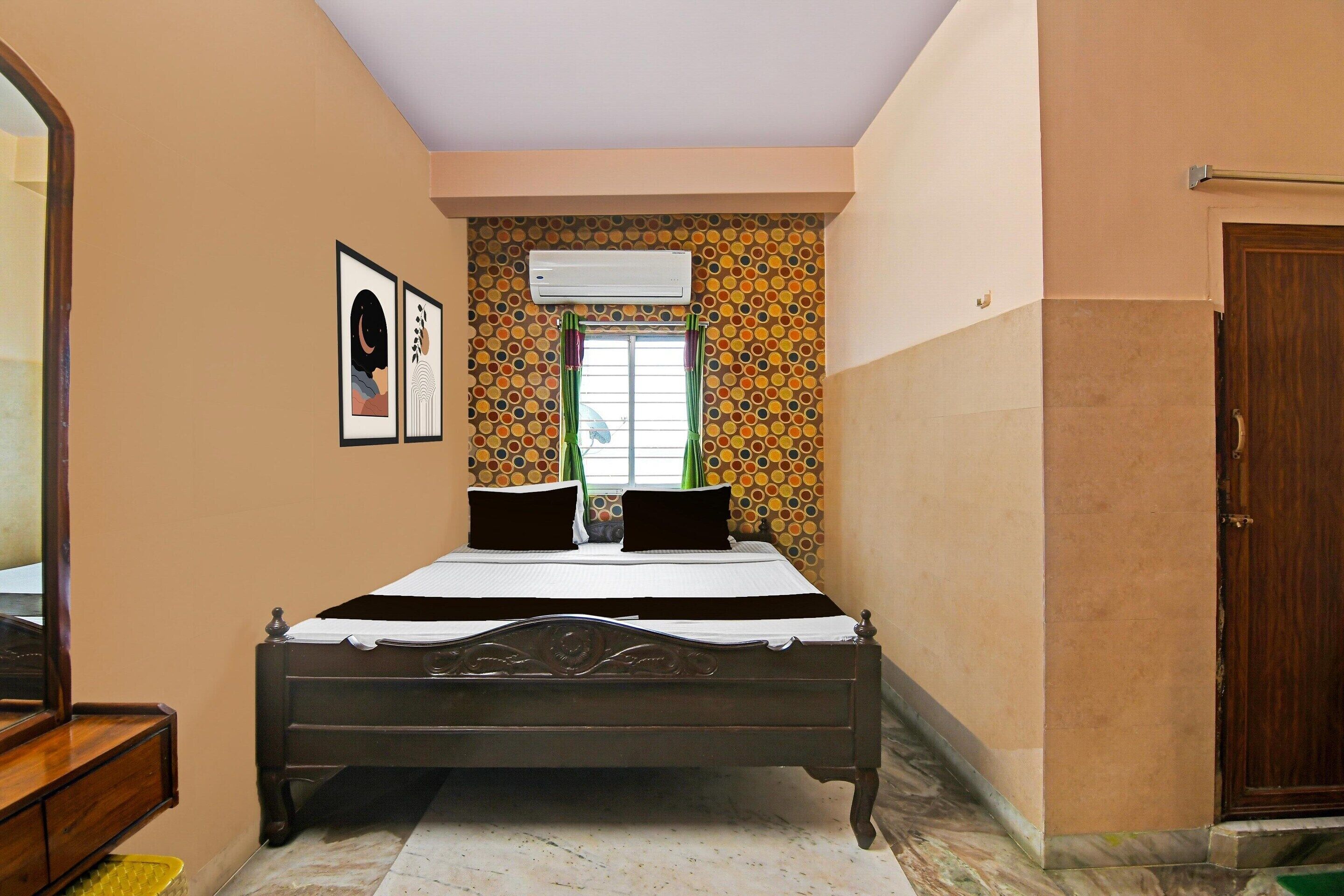 A bedroom with a bed, a dresser, an air conditioner, a window with curtains, and a door.