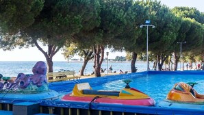 A water park with colorful water rides and a beach area. - Premium Family Base by Sea (Brtonigla)