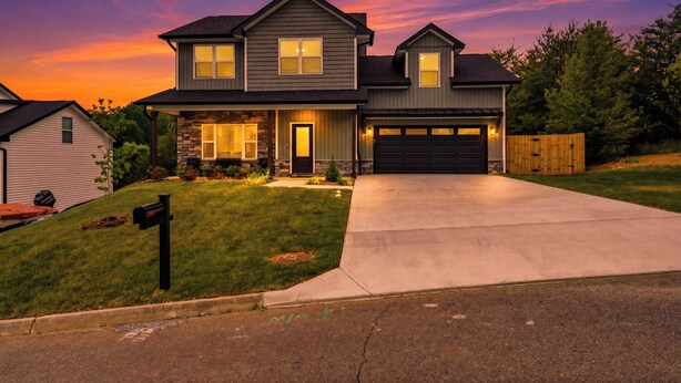 A two-story house with a garage, a front yard, and a mailbox. - SoKno Retreat, Pool Table, Sunroom, 15 min-Knox, 35-Sevier (Knoxville)