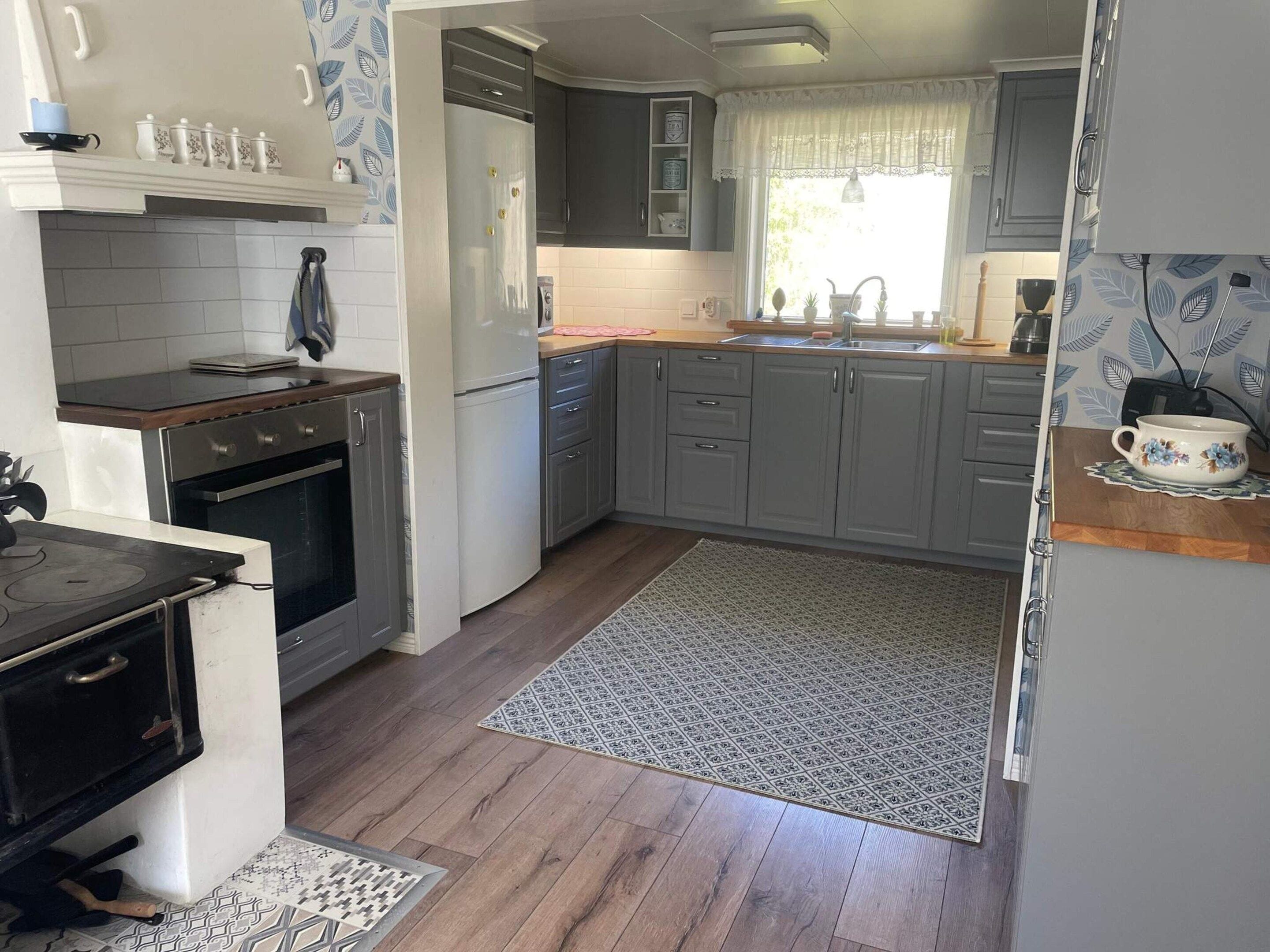A compact kitchen with a stove, oven, and a refrigerator.