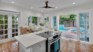 A spacious kitchen with a large island, a built-in oven, and a view of a swimming pool. - **VILLA PARADISO @ CASA EAST** Private Home & Pool + LAST KEY SERVICES… (Key West)