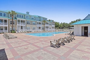 A pool area with lounge chairs, a swimming pool, and a building with balconies. - 🏖️Near the Beach | 4 Bikes | 30A | Pool | The Village 411🏖️ (Santa Rosa Beach)