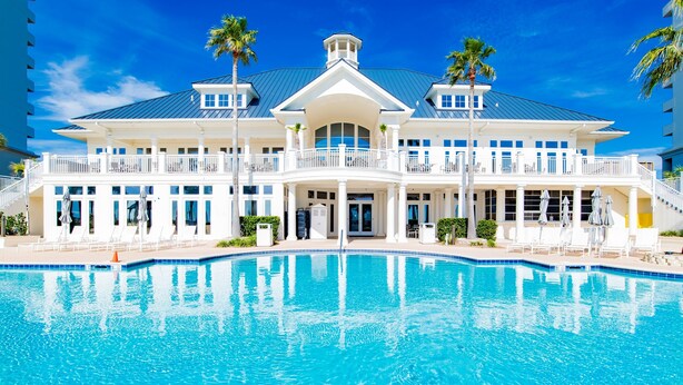 A large, two-story building with a swimming pool in front. - Beach Club D209- Direct Gulf View - Beach - Pool - WIFI (Gulf Shores)