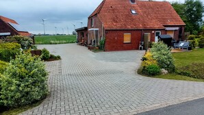 Ein Wohngebiet mit einem gepflasterten Einfahrt und einem Ziegelhaus mit roten Ziegelfliesen.