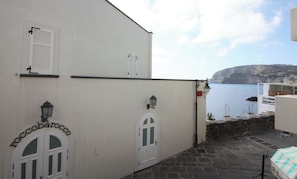 Un bâtiment à la façade blanche, doté de deux fenêtres en arc de cercle et d’une enseigne portant l’inscription « rocobarocco ».