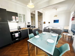 Una cocina moderna con comedor, una cama y un televisor.