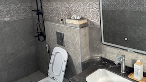 A modern bathroom with a shower, toilet, sink, and a mirror. - Strobia Luxury Chalet 3 Bedrooms 5 Bathrooms with Pool & Jacuzzi & Sunset Views (Allan)