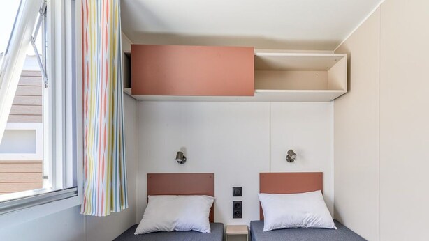 A compact room with two beds, a small table, and a window with curtains. - Adriatic Family Retreat With Terrace (Brtonigla)