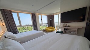 A hotel room with two beds, a flat-screen TV, a desk with a kettle, and a chair. - CP Tide whisper (Jinning)