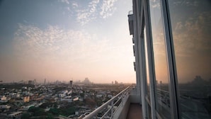 A high-rise building with a balcony overlooking a cityscape during sunset. - Apartment With Great View Near Beach & Walled City (Cartagena)