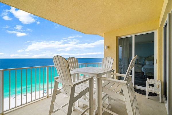 Private gulf-front balcony with high-top seating—perfect for dining with panoramic ocean views.