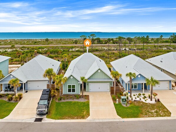 A coastal residential area with multiple houses, a clear view of the ocean, and a prominent house icon indicating a hotel. - Gulf & Bay Views | Golf Cart | Game Room | Pet Friendly (Port St Joe)