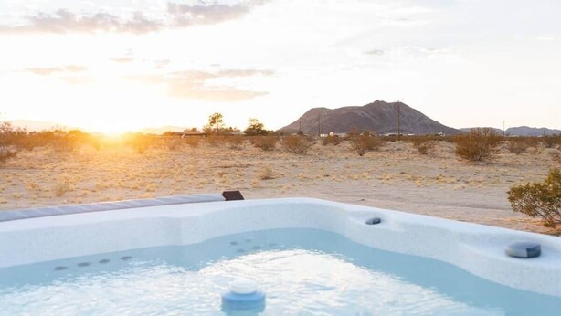 A hot tub in a desert landscape with mountains in the background. - DILIM - Designer Desert Retreat (Homestead Valley)